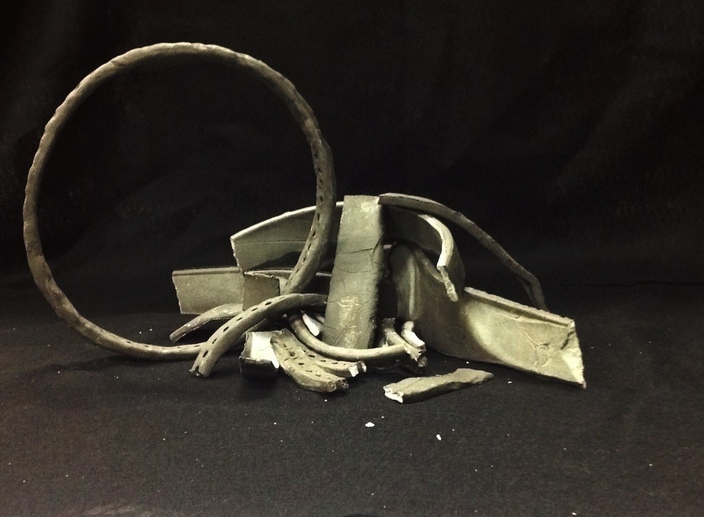 Sculpture made of broken air dry clay circles of different sizes.